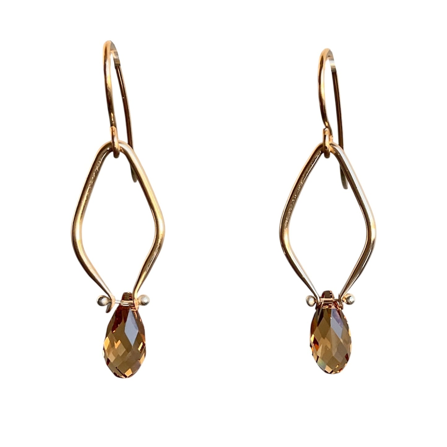 Gold earrings with golden brown teardrop-shaped gemstones on a white background