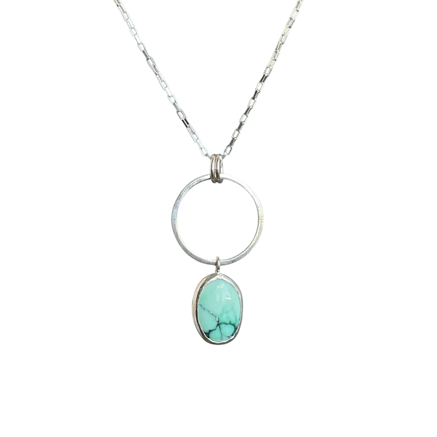 Circle element with a mint green oval varascite gemstone hanging. All on a sterling silver chain.