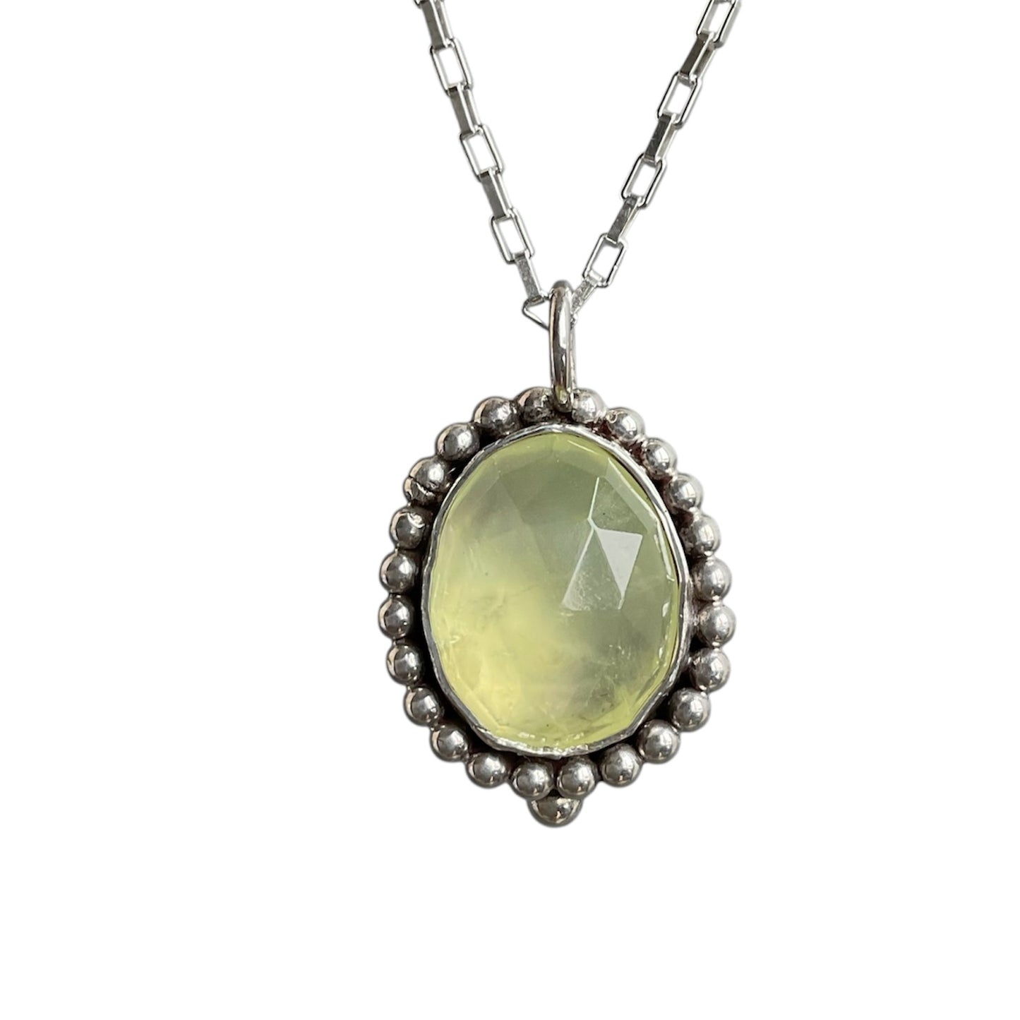 Necklace with a green pendant on a white background