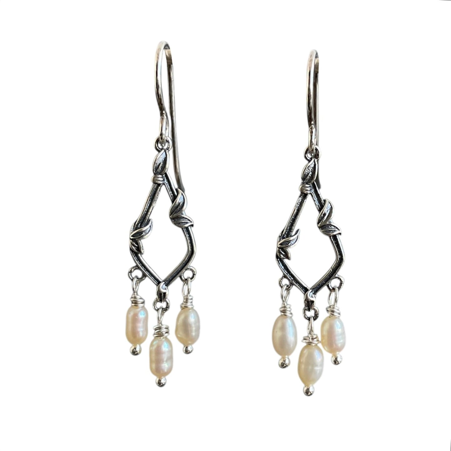 Sterling silver diamond drops with 3 fresh water pearls wire wrapped underneath. On sterling silver ear wires