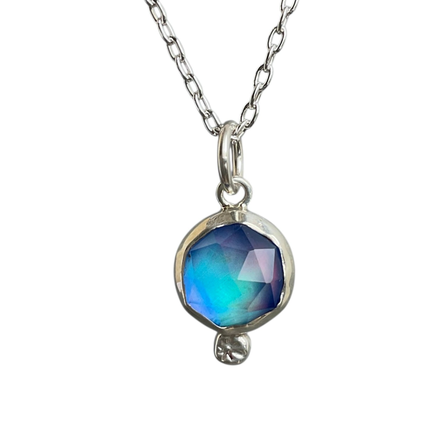 Necklace with a blue faceted pendant on a white background