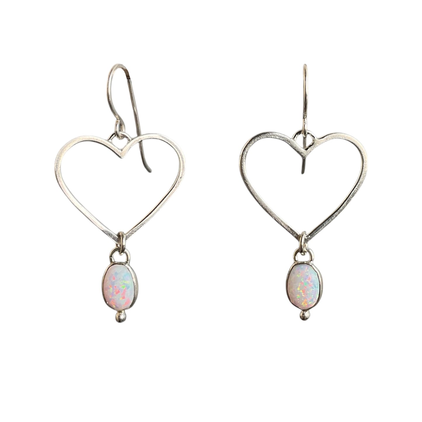 Heart-shaped silver earrings with opal stones on a white background