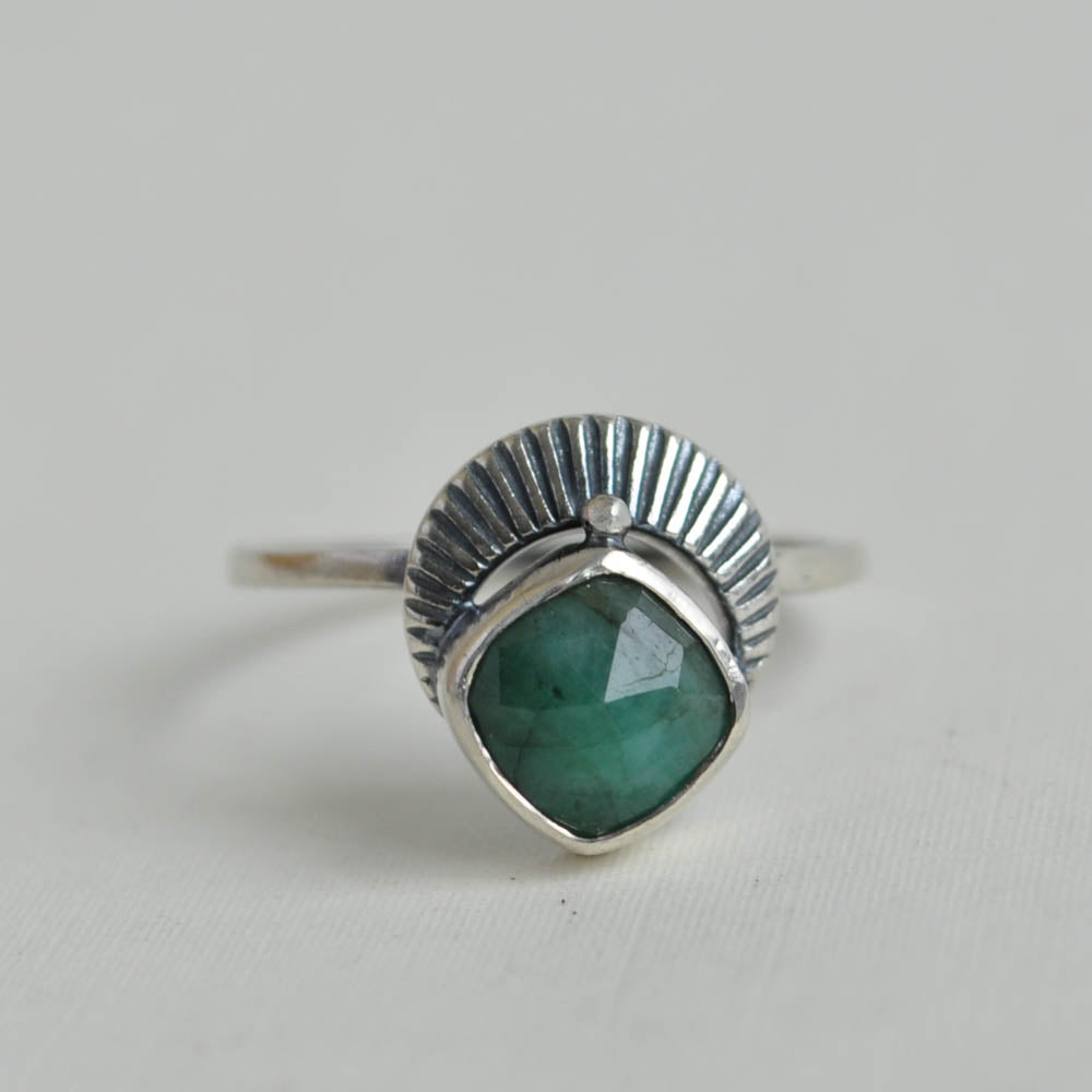 Emerald gemstone set with a crescent moon ring band.