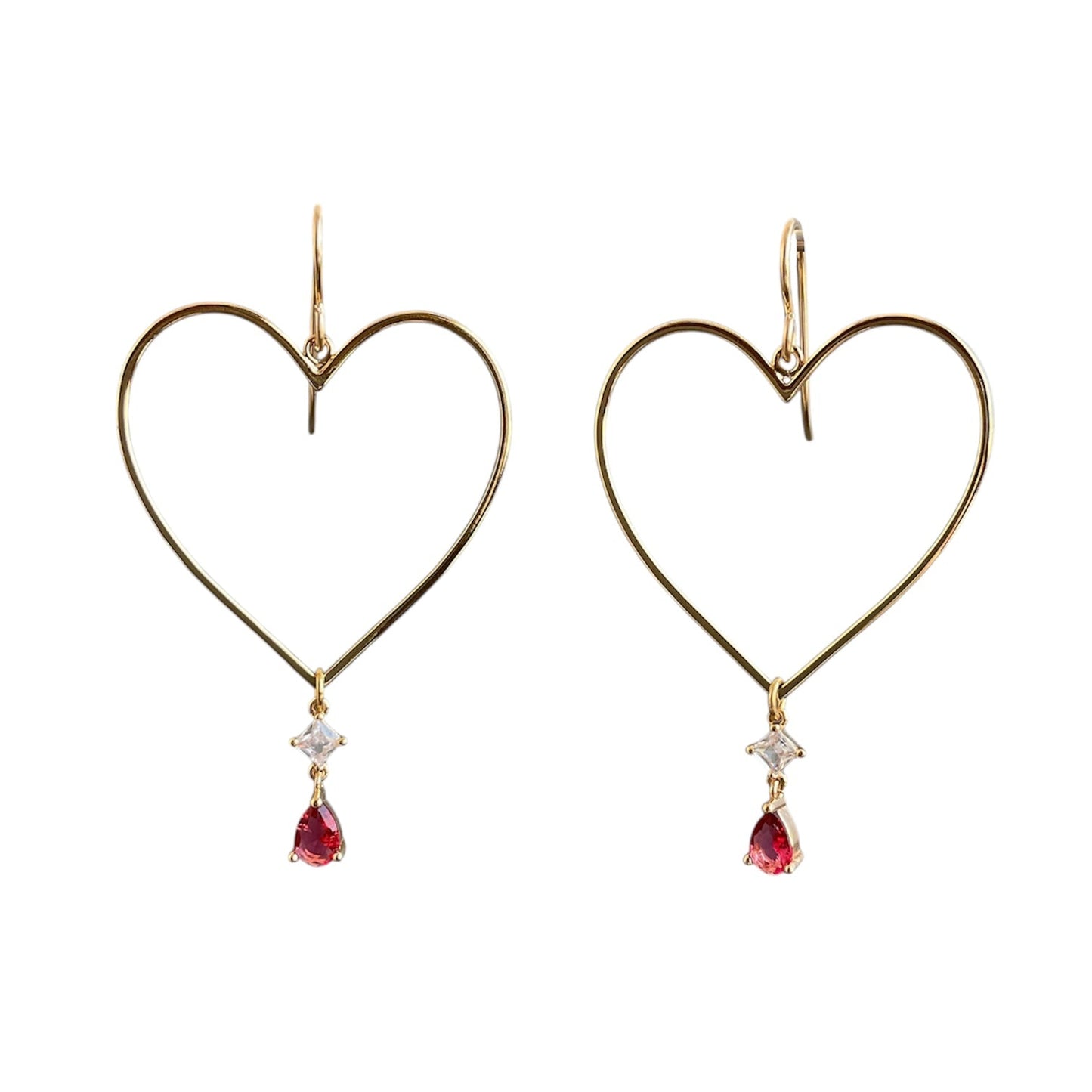 Gold heart drop earrings with ruby gemstones hanging from the bottom point.