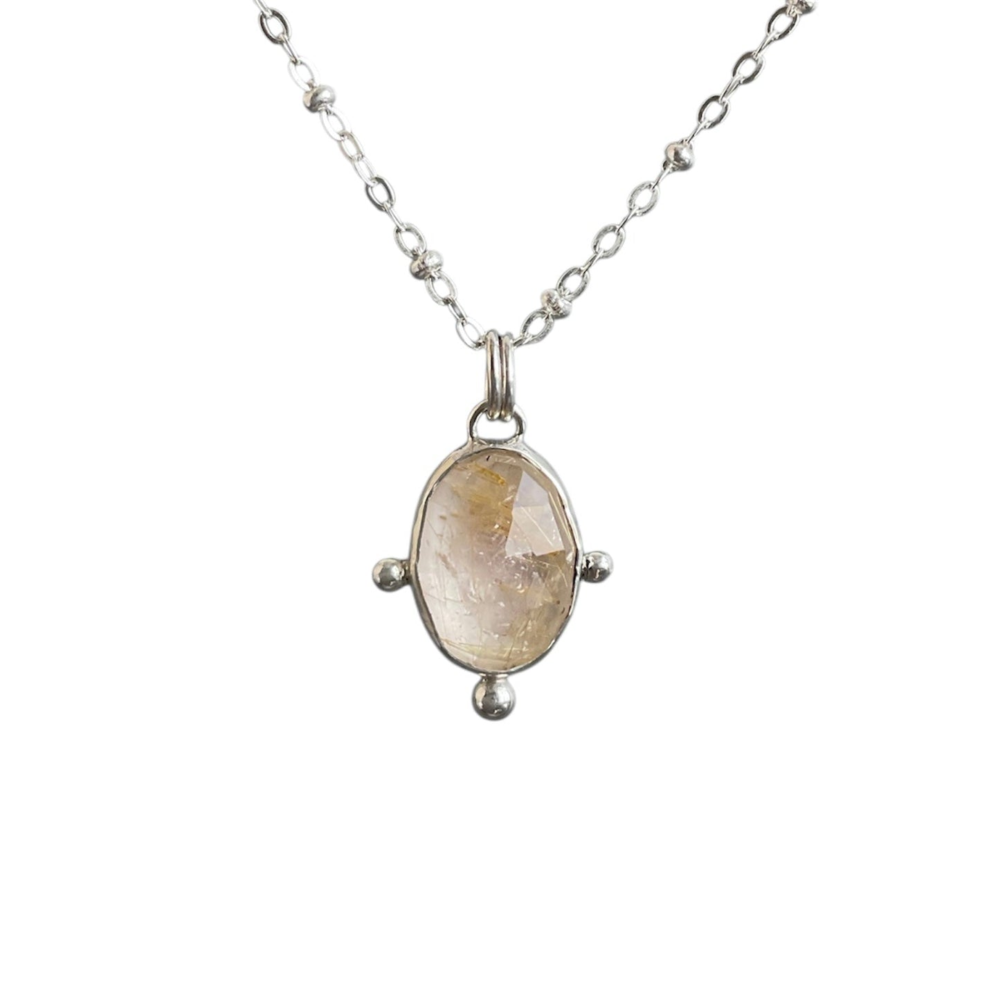 Sparkly quartz with golden rutiles bezel set in stelring silver with bead embellishments. Solid sterling silver setting and chain.