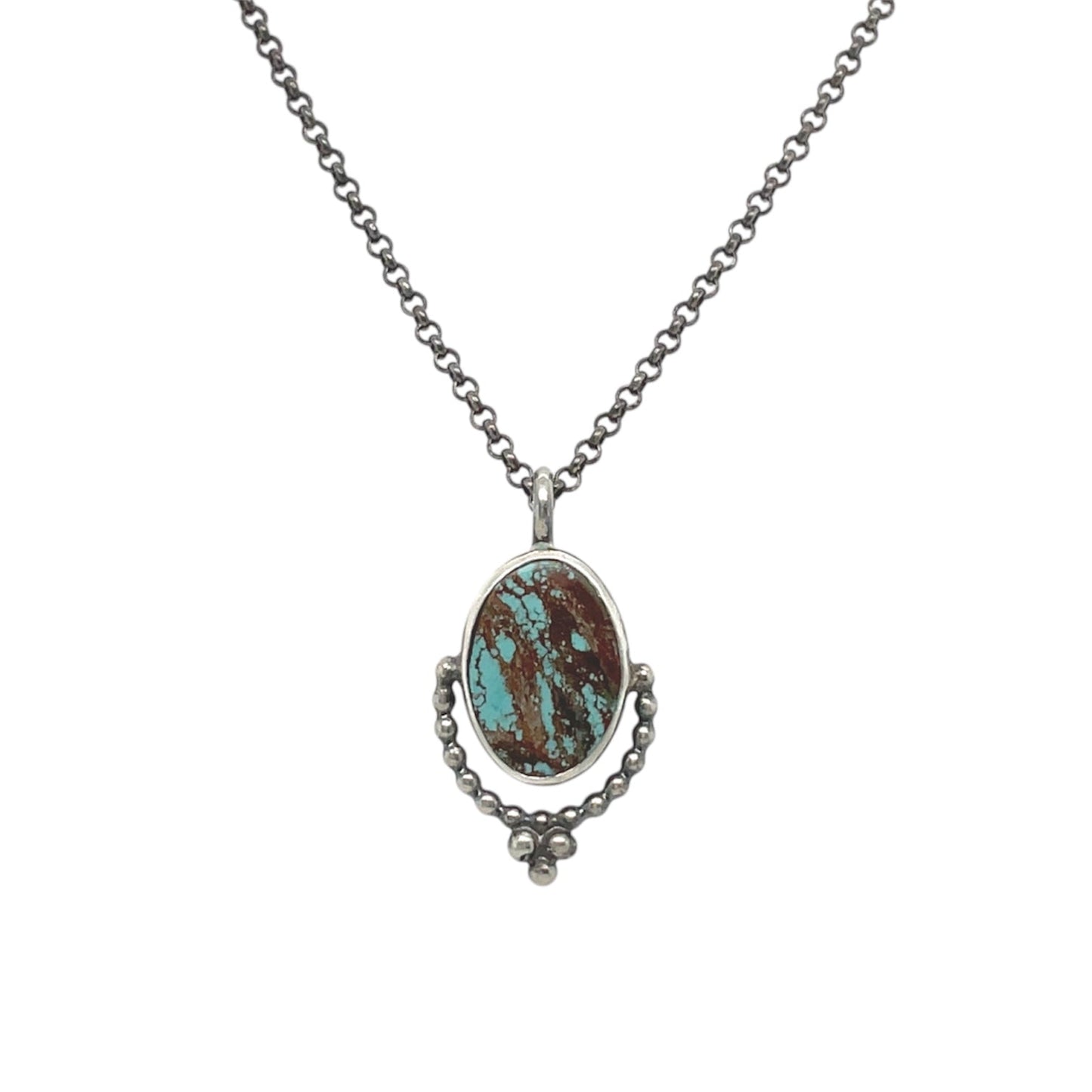 A dreamy smooth oval turquoise stone necklace set in sterling silver and embellished with a beaded tri-drop.