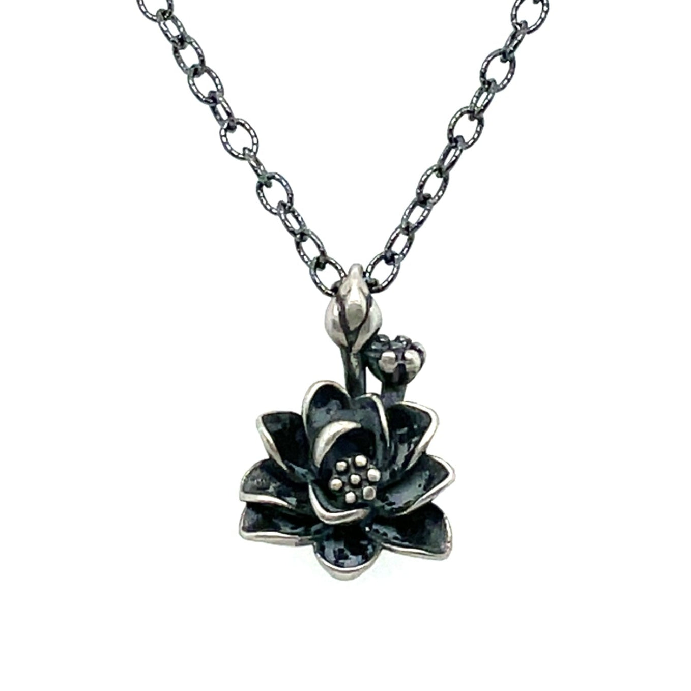 A sterling silver necklace with a oxidized finish featuring a lotus flower pendant.