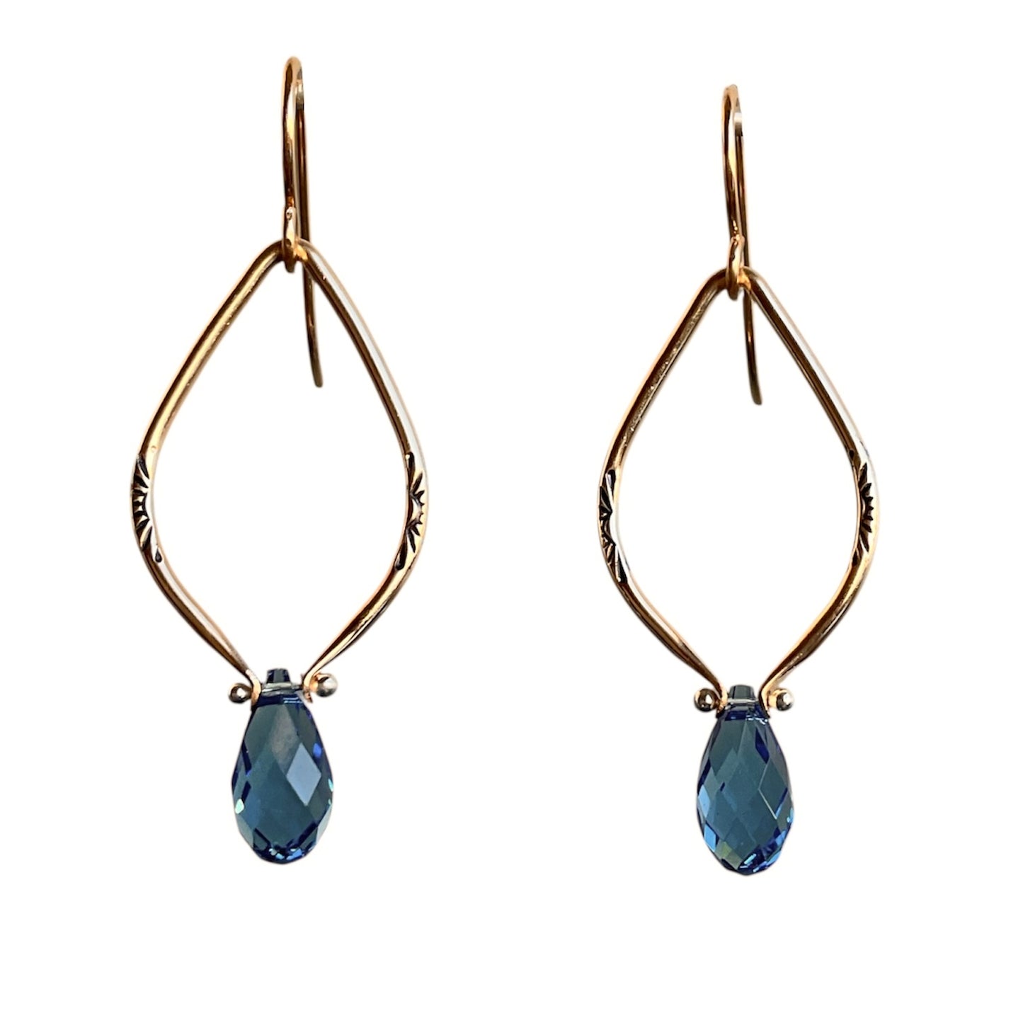 Gold earrings with blue teardrop-shaped stones on a white background