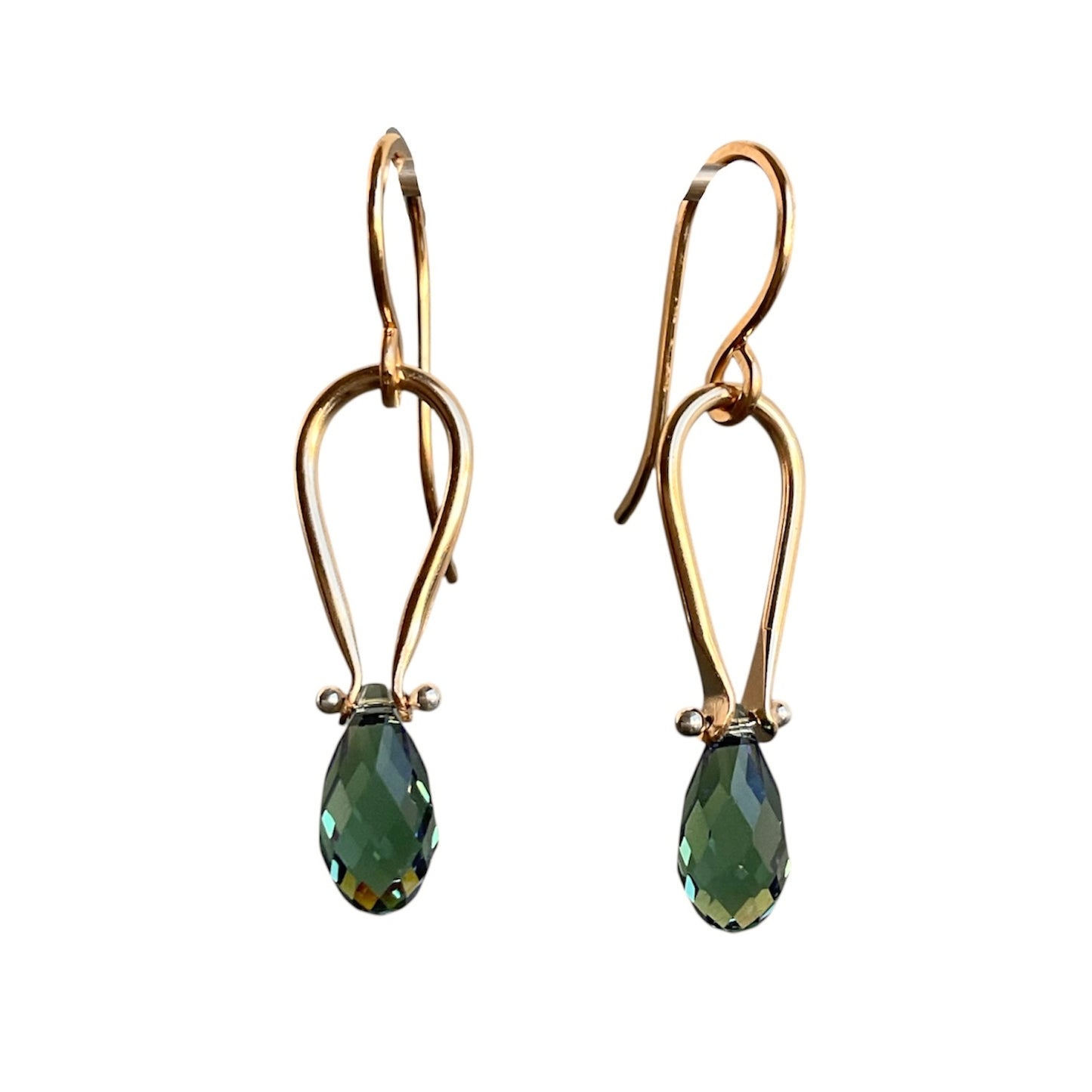Gold earrings with green teardrop-shaped gemstones on a white background