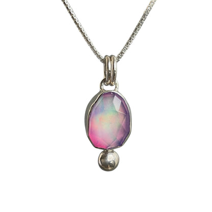 Necklace with a pendant featuring a colorful gemstone on a white background
