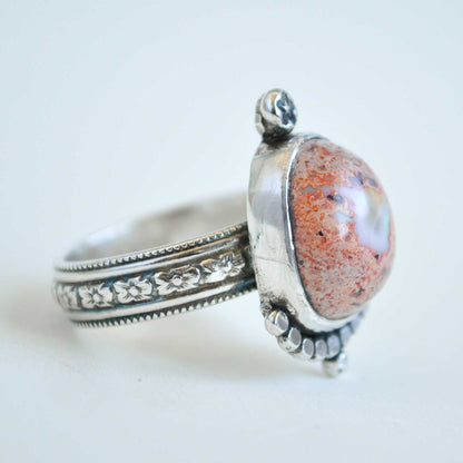 Silver ring with a large stone on a white background
