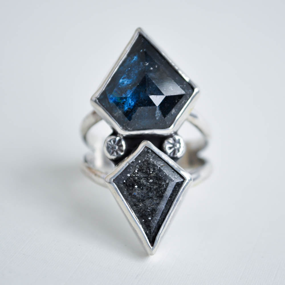 Sterling silver statement ring featuring two kite shaped gemstones- teal kyanite and salt and pepper sunstone. 