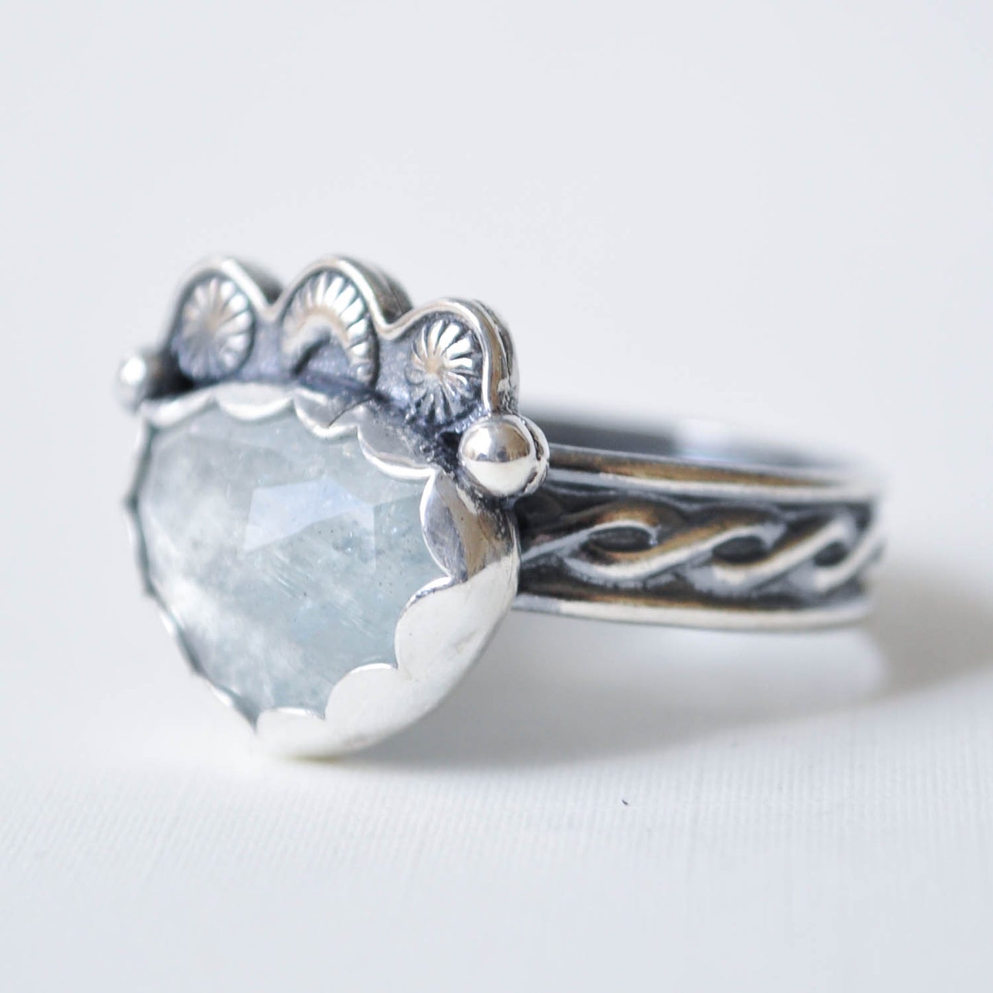 Silver ring with a large gemstone on a white background