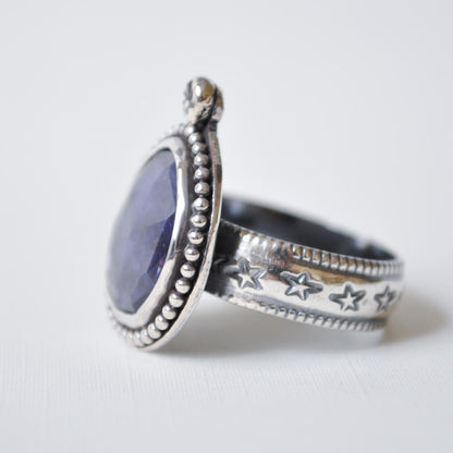 Silver ring with star designs on a white background
