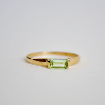 Green peridot baguete gemstone set horiztonally on a classic half round ring band in sterling silver and 14k gold vermeil