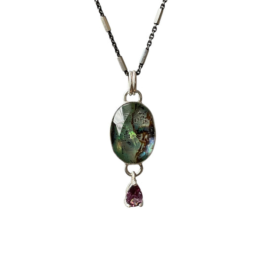 Necklace with a labradorite pendant and a small purple gemstone on a white background