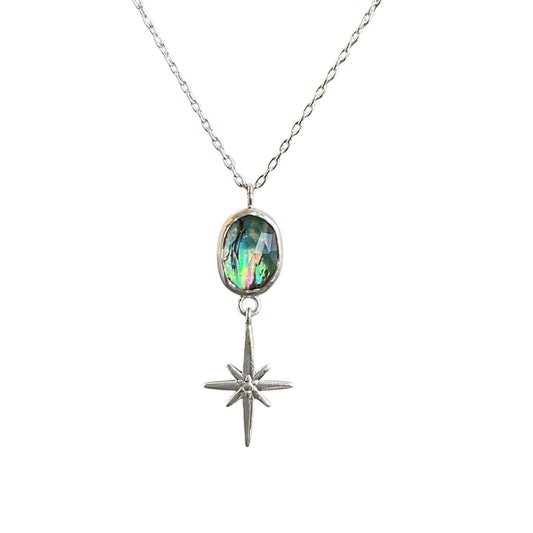 Faceted blue and green oval abalone gemstone with a north star charm hanging underneath. 