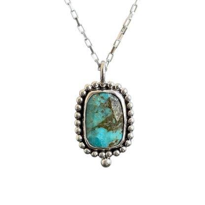 Turquoise pendant necklace on a white background