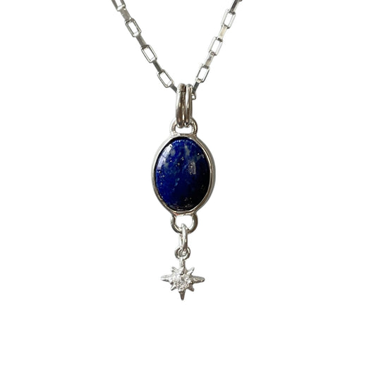 Necklace with a blue stone pendant and star charm on a white background
