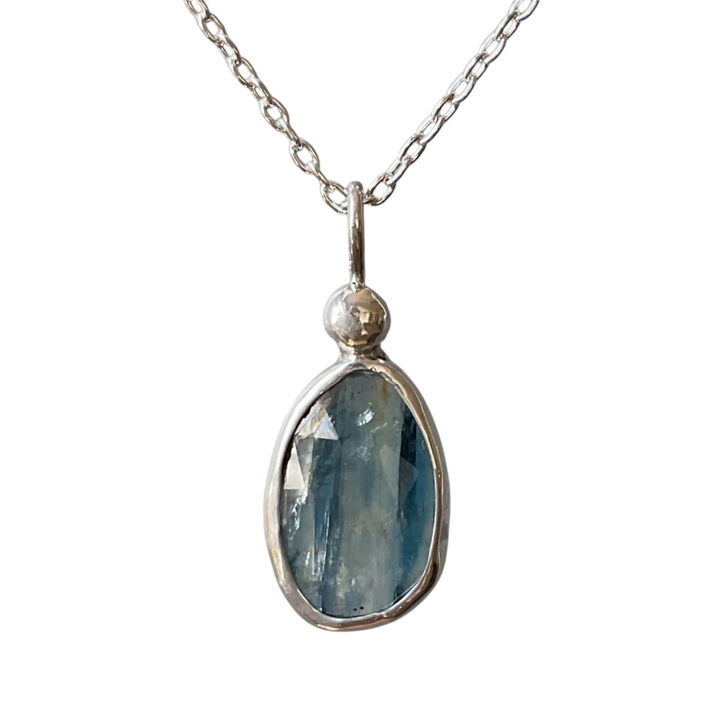 Silver necklace with a blue pendant on a white background