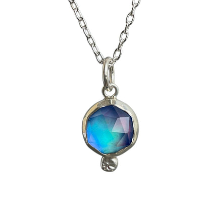Necklace with a blue faceted pendant on a white background
