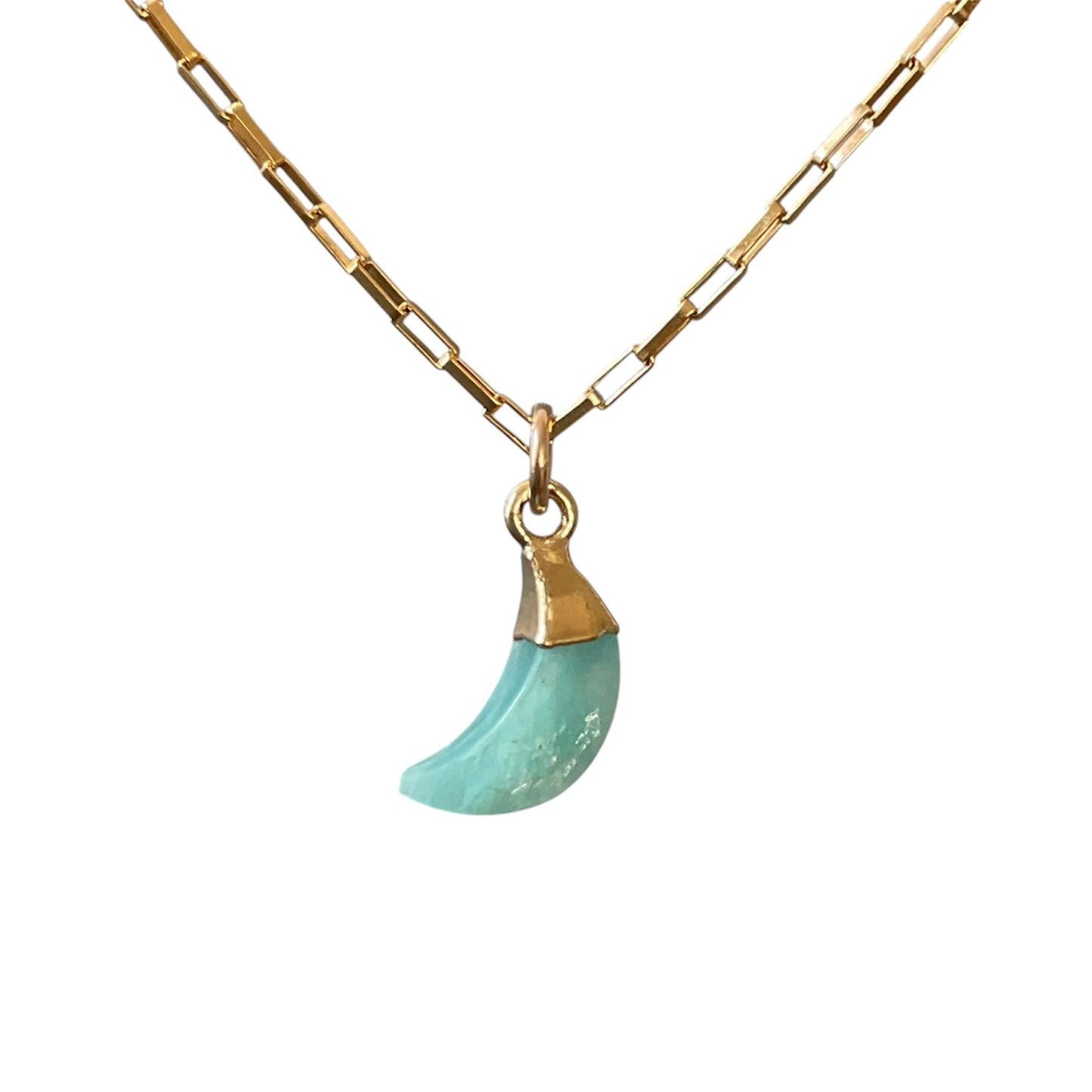 Gold necklace with a turquoise pendant on a white background