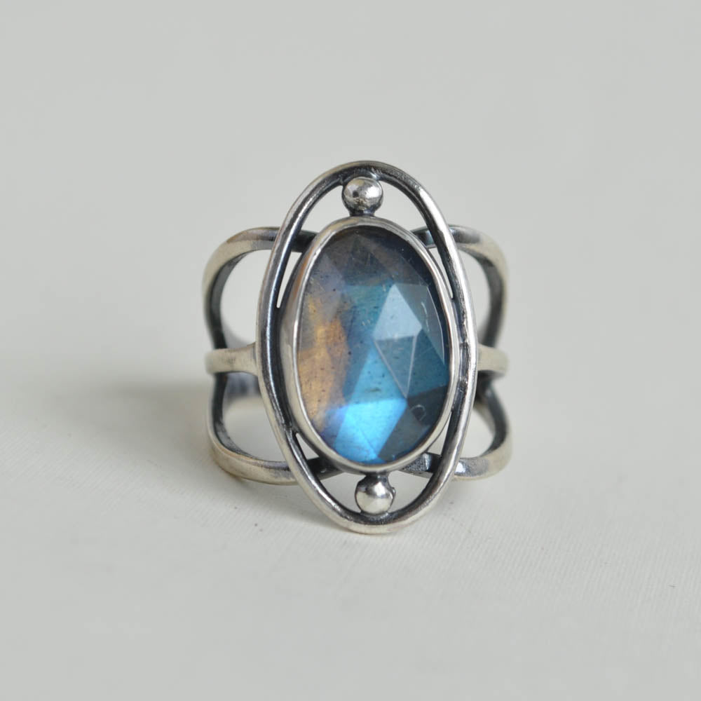 Flashy blue labradorite gemstones set on a cosmic band with a wire border and north, south accent beads. 