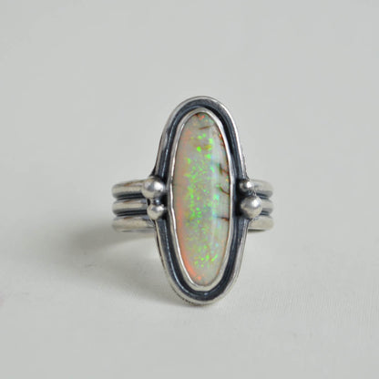 Green-yellow sterling opal gemstone bezel set in sterling silver on a triple half round band.