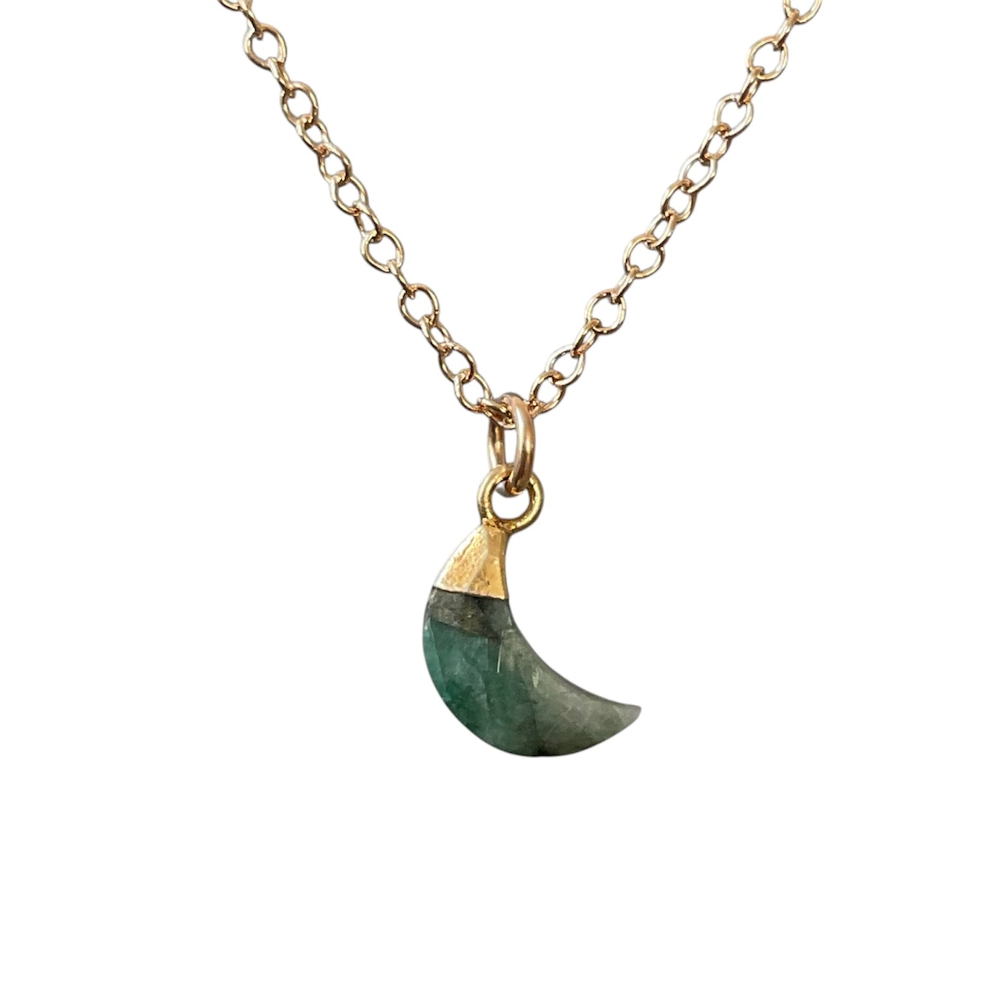 Necklace with a green crescent moon pendant on a gold chain against a white background
