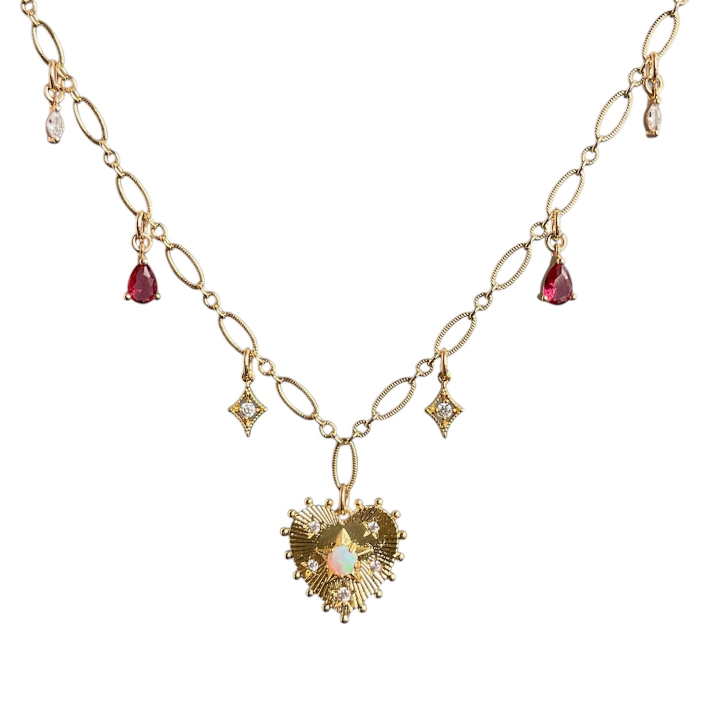 Gold necklace with heart pendant and gemstones on a white background