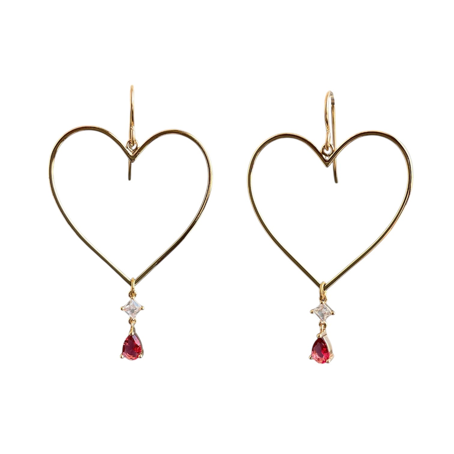 Gold heart drop earrings with ruby gemstones hanging from the bottom point. 