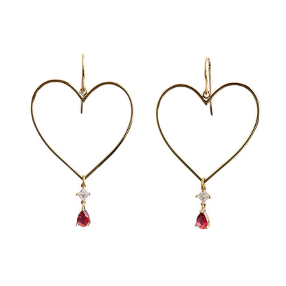 Gold heart drop earrings with ruby gemstones hanging from the bottom point. 