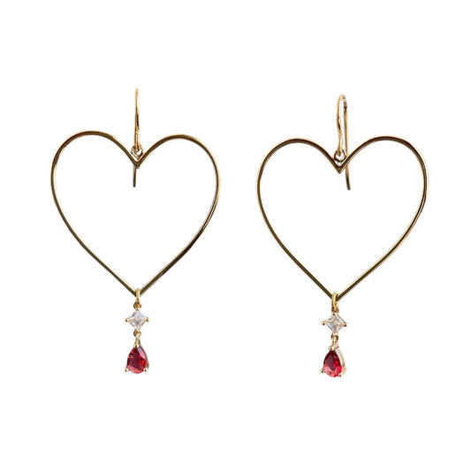 Gold heart drop earrings with ruby gemstones hanging from the bottom point. 