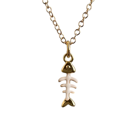 Gold and white fish bone pendant necklace on a white background