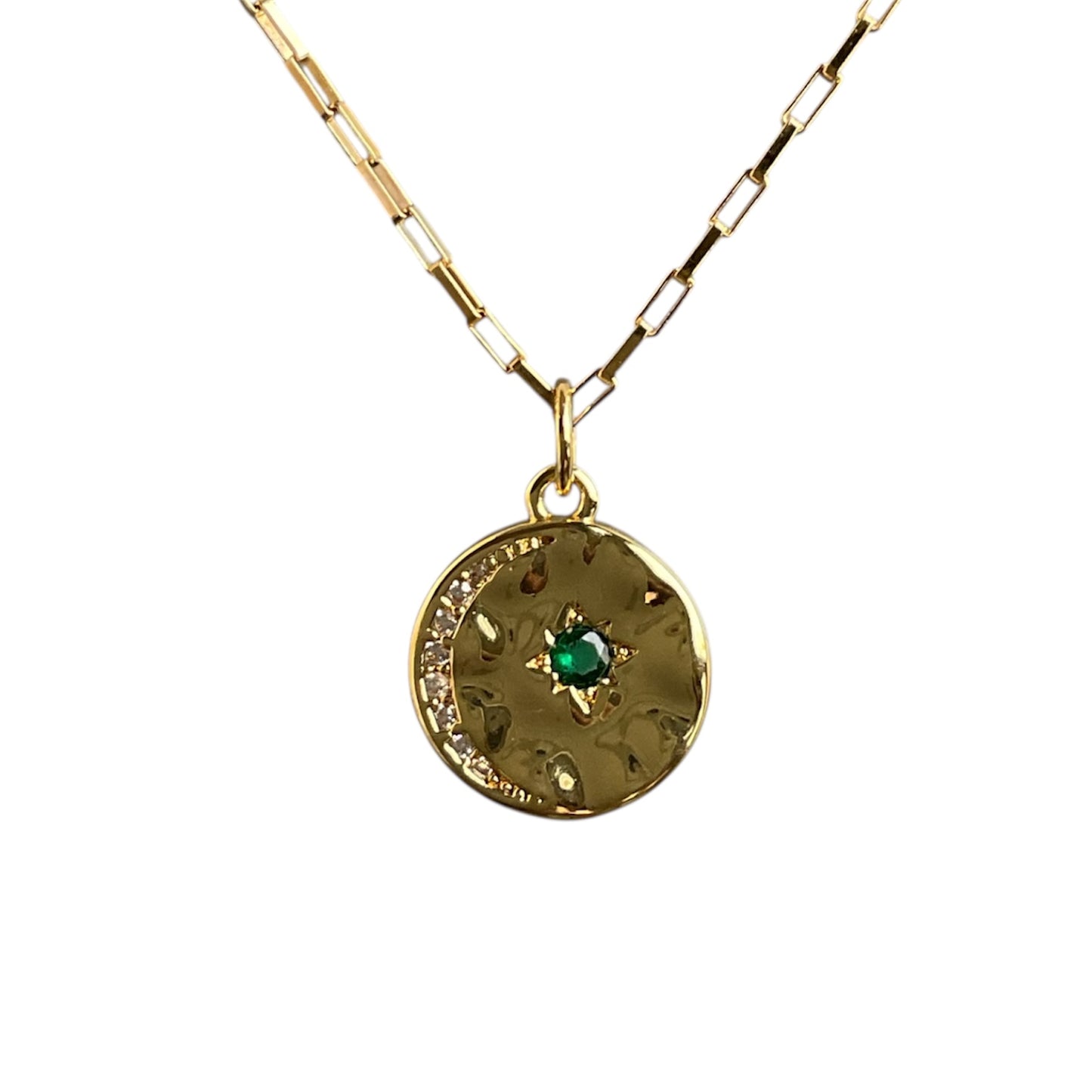 Gold necklace with a pendant featuring a green gemstone on a white background