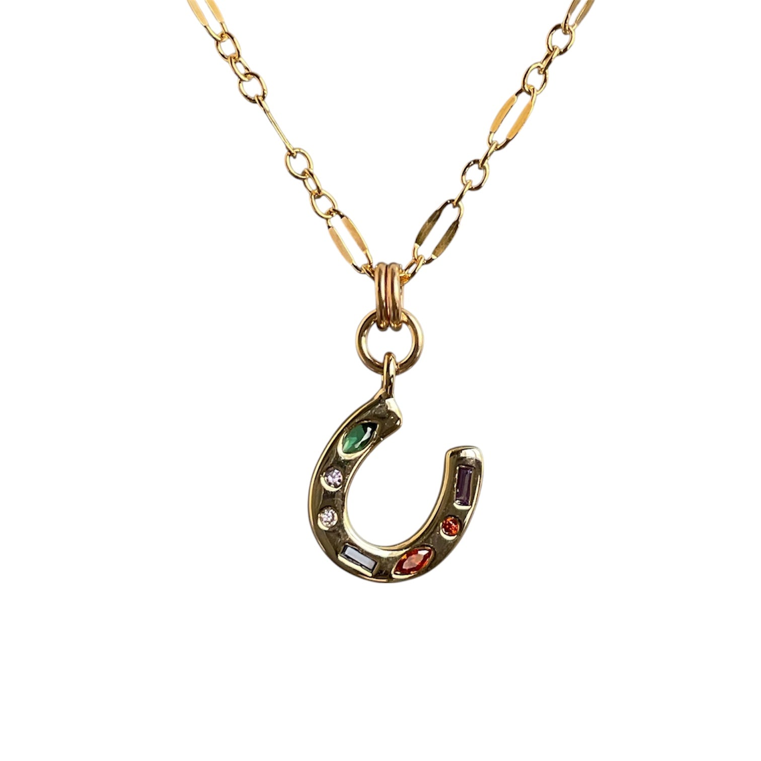 Gold necklace with a horseshoe pendant featuring colorful stones on a white background