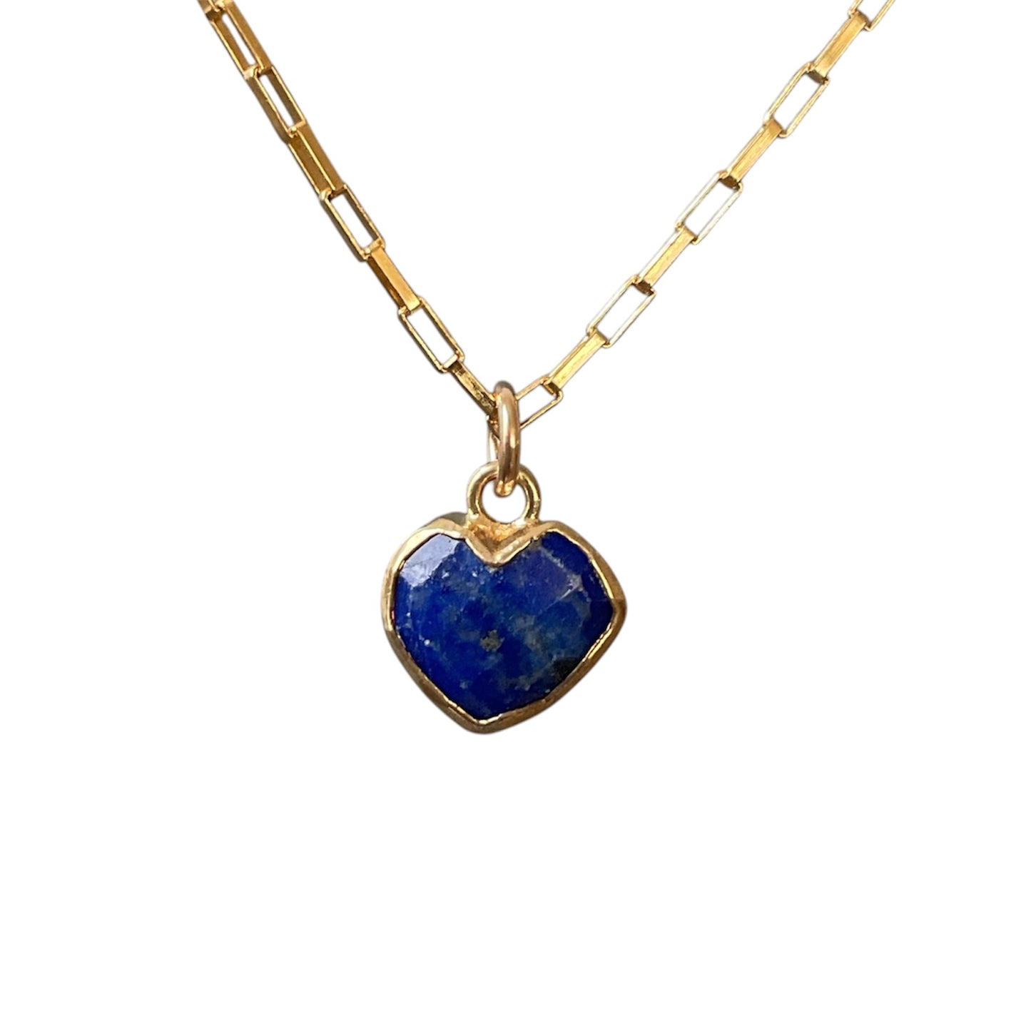 Gold necklace with a heart-shaped lapis lazuli pendant on a white background
