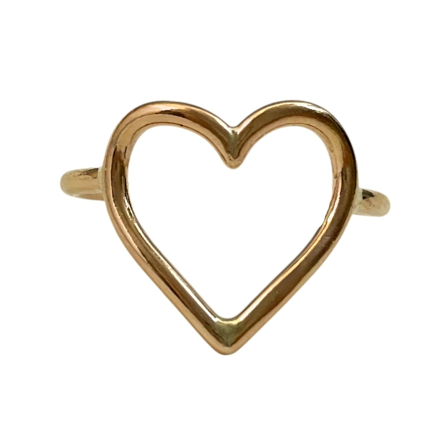 Gold heart-shaped ring on a white background
