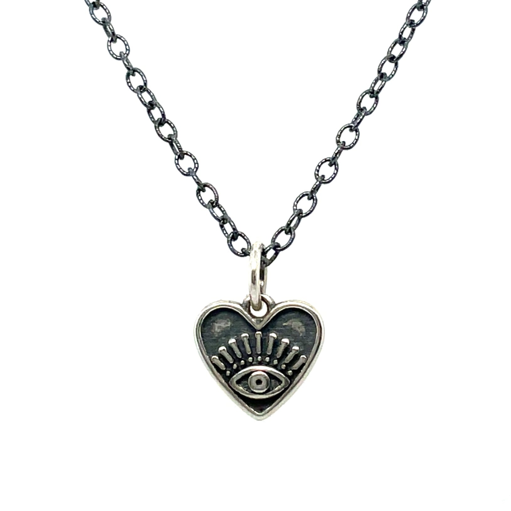A necklace with an oxidized sterling silver chain and a heart-shaped pendant with an eye design in the center.